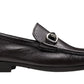 The Magnanni Gentry Soft Bit Loafer in black leather, with a metal buckle and textured finish, features a cushioned sole for comfort. Shown from the side against a white background.