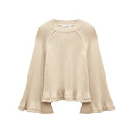The Cotton Candy Pullover by Dorothee Schumacher is a beige knit cropped top with wide raglan sleeves and a loose, slightly ruffled hem, shown on a white background.