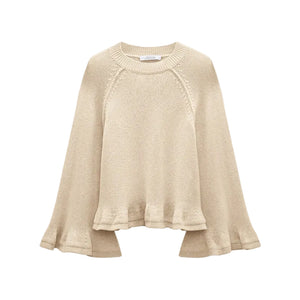 The Cotton Candy Pullover by Dorothee Schumacher is a beige knit cropped top with wide raglan sleeves and a loose, slightly ruffled hem, shown on a white background.
