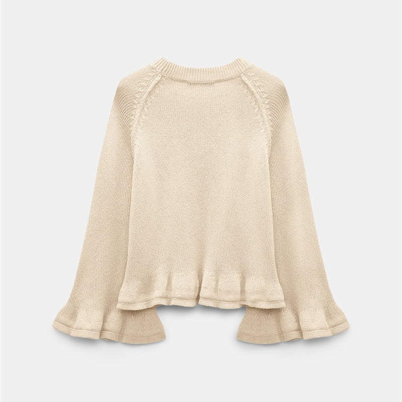 The Dorothee Schumacher Cotton Candy Pullover is a cream-colored cotton sweater featuring long, flared raglan sleeves and a relaxed fit, shown against a plain white background.