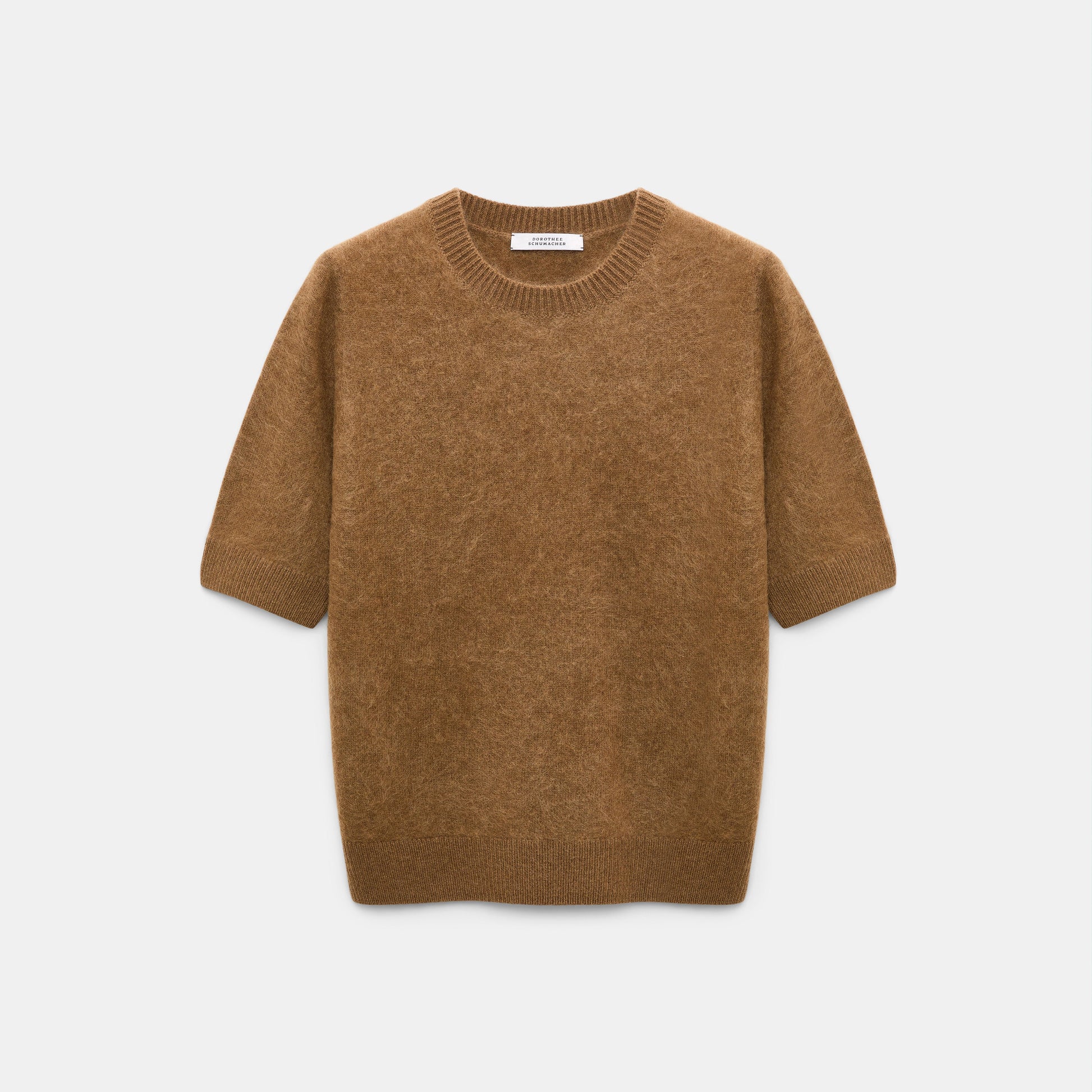 The Fluffy Statements Pullover by Dorothee Schumacher, a short-sleeved brown knit merino-cashmere sweater, is displayed on a plain white background.