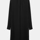 The Statement Drape Dress by Dorothee Schumacher is a long-sleeve, knee-length black dress made from luxurious Japanese crepe, showcasing a high neckline and a straight, loose fit, presented from the back.