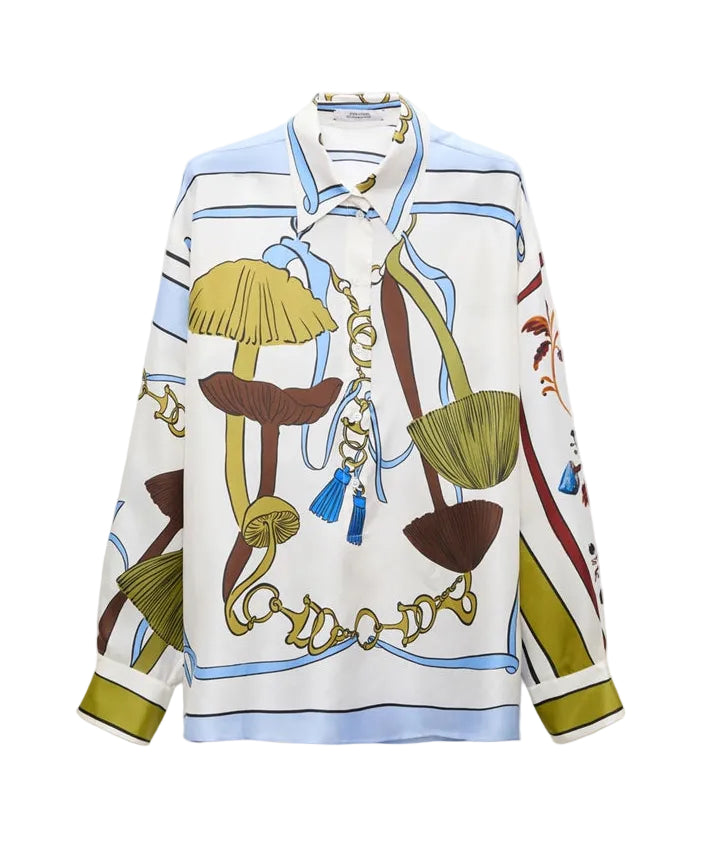Dorothee Schumacher’s Cosmic Funghi Blouse is a long-sleeve button-up crafted in silk twill, showcasing a vibrant oversized mushroom and chain print in shades of blue, olive, and brown on a white background.