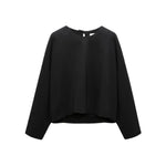 The Dorothee Schumacher Emotional Essence Blouse is an oversized black long-sleeve pullover top with a round neckline, shown on a white background.