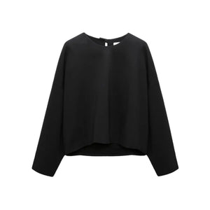 The Dorothee Schumacher Emotional Essence Blouse is an oversized black long-sleeve pullover top with a round neckline, shown on a white background.