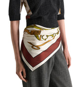 A person wears the Dorothee Schumacher Cuoio Softness Scarf Belt tied around their waist over a dark knit top and plaid pants.
