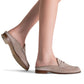 A person wearing the Magnanni Carissa Suede Mule Penny in light beige stands on a white background, highlighting the elegance of this classic women's slip-on mule loafer with wooden soles.