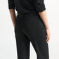 A person wearing a shimmering Merino-Lurex top and matching Shimmering Merino Trouser flared trousers.