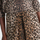 A person wearing a long-sleeved top and a matching Wild at Heart Skirt midi-skirt with a leopard print.