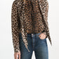 Dorothee Schumacher Wild at Heart blouse in leopard print viscose georgette with a pussy-bow necktie, worn with blue jeans.