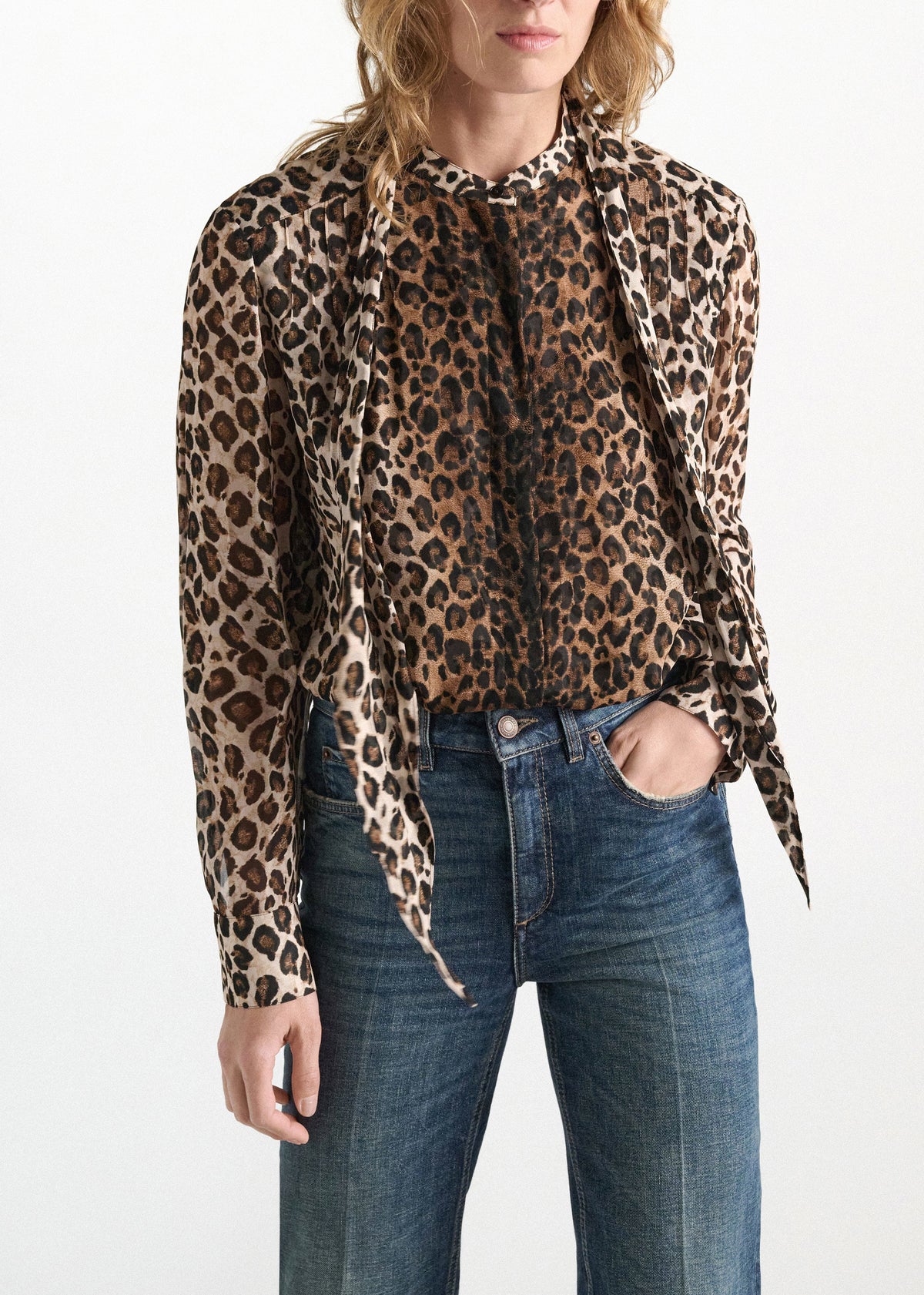 Dorothee Schumacher Wild at Heart blouse in leopard print viscose georgette with a pussy-bow necktie, worn with blue jeans.