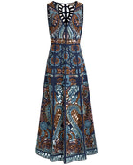 The Vivienne Brise Dress by Emporio Sirenuse is a sleeveless, mid-length dress with geometric and floral Brisé cutwork in blue, brown, and copper tones, featuring a fitted bodice and flared skirt.