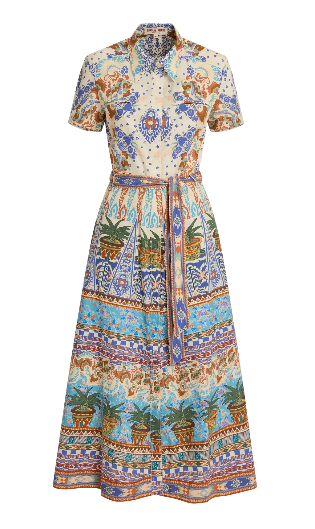 The Emporio Sirenuse Giselle Chimera Dress is a short-sleeve, button-up style with a belted waist, featuring a vibrant print inspired by Indonesian textiles in blue, orange, and green with florals, palms, and geometric motifs.