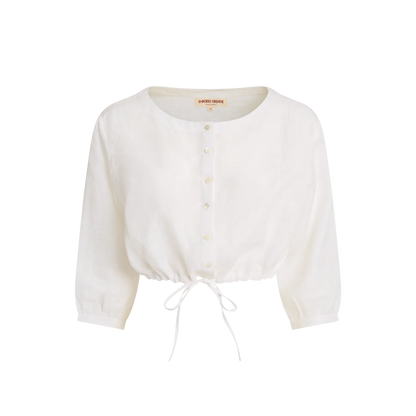 Emporio Sirenuse presents the New Jinny Blue Horizon Top, a white long-sleeve button-up blouse with a round neckline and adjustable drawstring hem, inspired by the relaxed elegance of a linen cropped top, shown on a plain background.