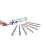 A hand holds a translucent clear rail piece next to an open Magnatiles Rail Racers 8-Piece Rail Pack box, with seven similar rails arranged in a row on a white surface.