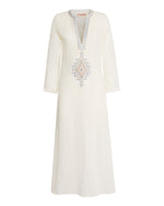 The Jenna Meridiana Dress by Emporio Sirenuse is a long-sleeve white linen-cotton blend, detailed with blue and tan Meridiana embroidery along the V-neck and chest for a touch of effortless elegance.