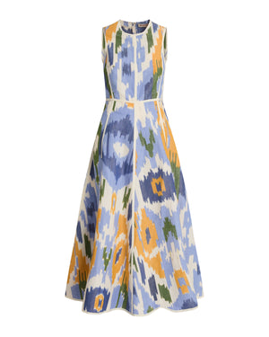 The Clodette Watercolor Ikat Dress by Emporio Sirenuse is a sleeveless, ankle-length fit-and-flare dress with a flared skirt, showcasing a bold blue, yellow, green, and white abstract pattern inspired by antique Uzbek textiles.