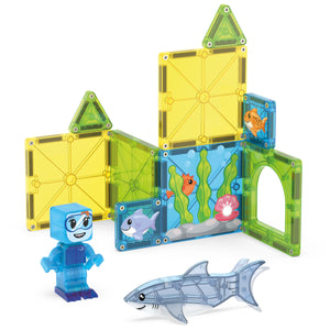 The Magnatiles Shark Dive 13-Piece Set features vibrant magnetic tiles that create an ocean-themed structure with fish motifs, ideal for imaginative underwater adventures. The set includes a blue block figure and a translucent shark accessory.