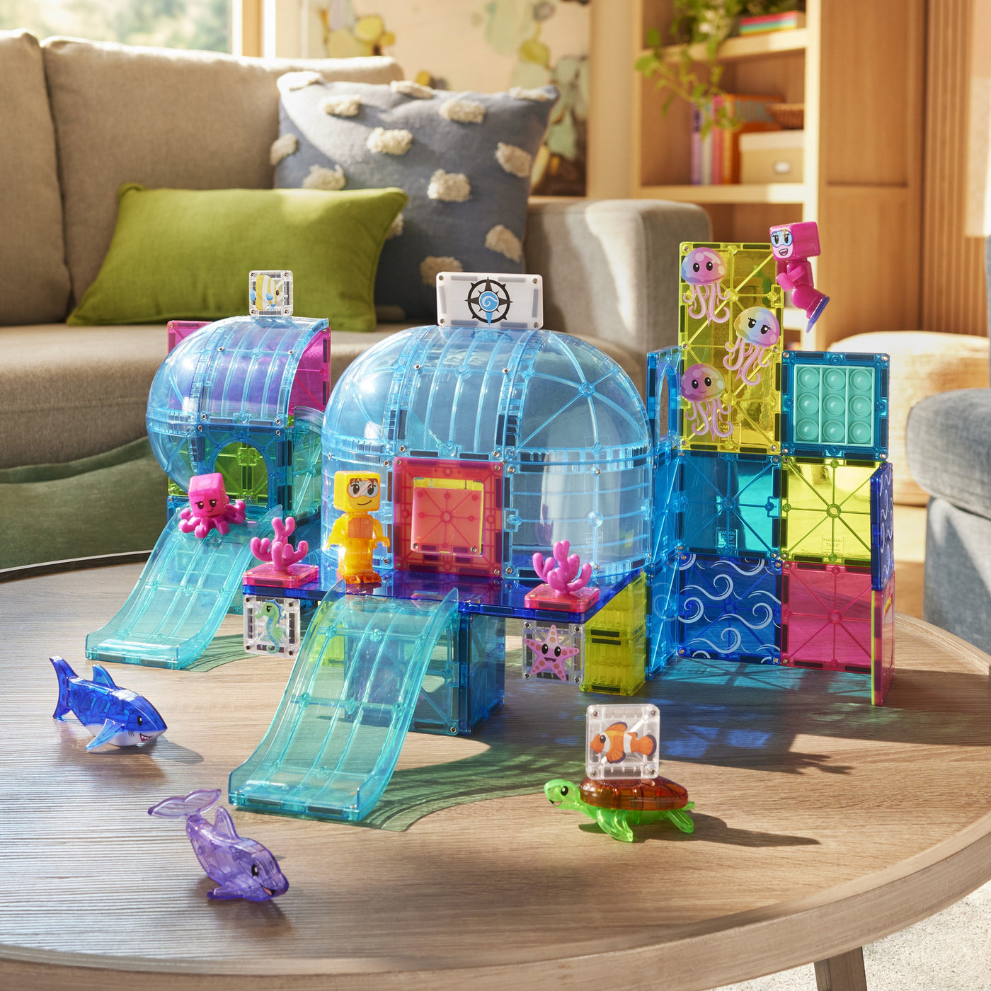 The MAGNA-TILES Undersea Adventure 58-Piece Set features colorful magnetic building pieces and plastic sea creature figures—including a turtle, dolphin, and octopus—to create the perfect aquarium-themed playset for undersea adventures right on your living room table.