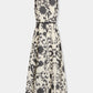 Clodette Ikat Blossom Dress, a sleeveless A-line midi dress in cream and charcoal floral print with solid black trim at the neckline, waist, and hem.