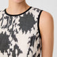 Clodette Ikat Blossom Dress in a black and cream pattern with black trim at the neck and armholes.