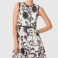 Emporio Sirenuse Clodette Ikat Blossom Dress, a sleeveless handloomed linen-cotton dress in a black and white ikat blossom print with black trim at the neck, armholes, and waist.
