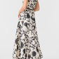 Emporio Sirenuse Clodette Ikat Blossom Dress, a sleeveless, ankle-length monochrome floral dress featuring a black and white ikat pattern with black trim.
