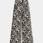 Emporio Sirenuse Adele Lotus Flower pants with a wide-leg silhouette and a black and white floral damask print.