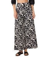 Emporio Sirenuse Adele Lotus Flower high-rise flared pants in a black and white floral damask pattern.