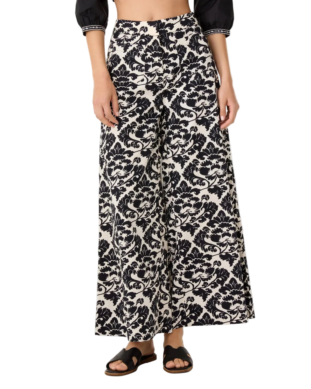 Emporio Sirenuse Adele Lotus Flower high-rise flared pants in a black and white floral damask pattern.