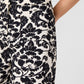 Emporio Sirenuse Adele Lotus Flower Pants in cream-colored cotton drill with a bold, black lotus flower damask pattern.