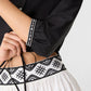 Emporio Sirenuse New Jinny Peony Embroidery Top in black cotton poplin with three-quarter sleeves, paired with a white skirt featuring matching geometric black and white peony embroidery.