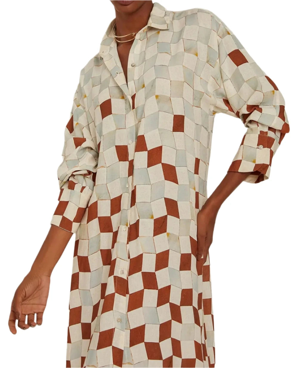 An individual is dressed in a Lenny Niemeyer Comfort Button Up Shirt Dress, showcasing a checkered geometric pattern in beige and rust tones.