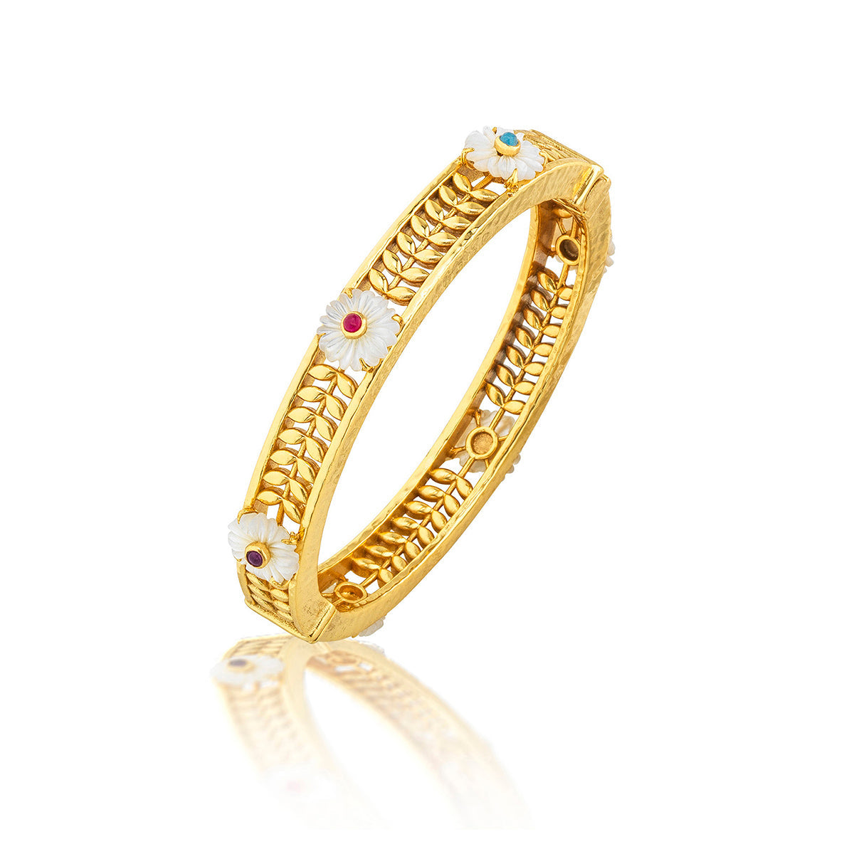 The Juliska Capucine De Wulf Villandry Fleur Vine Hinged Bangle features white floral accents and colorful gemstone centers, inspired by mother of pearl, shown on a reflective white background.