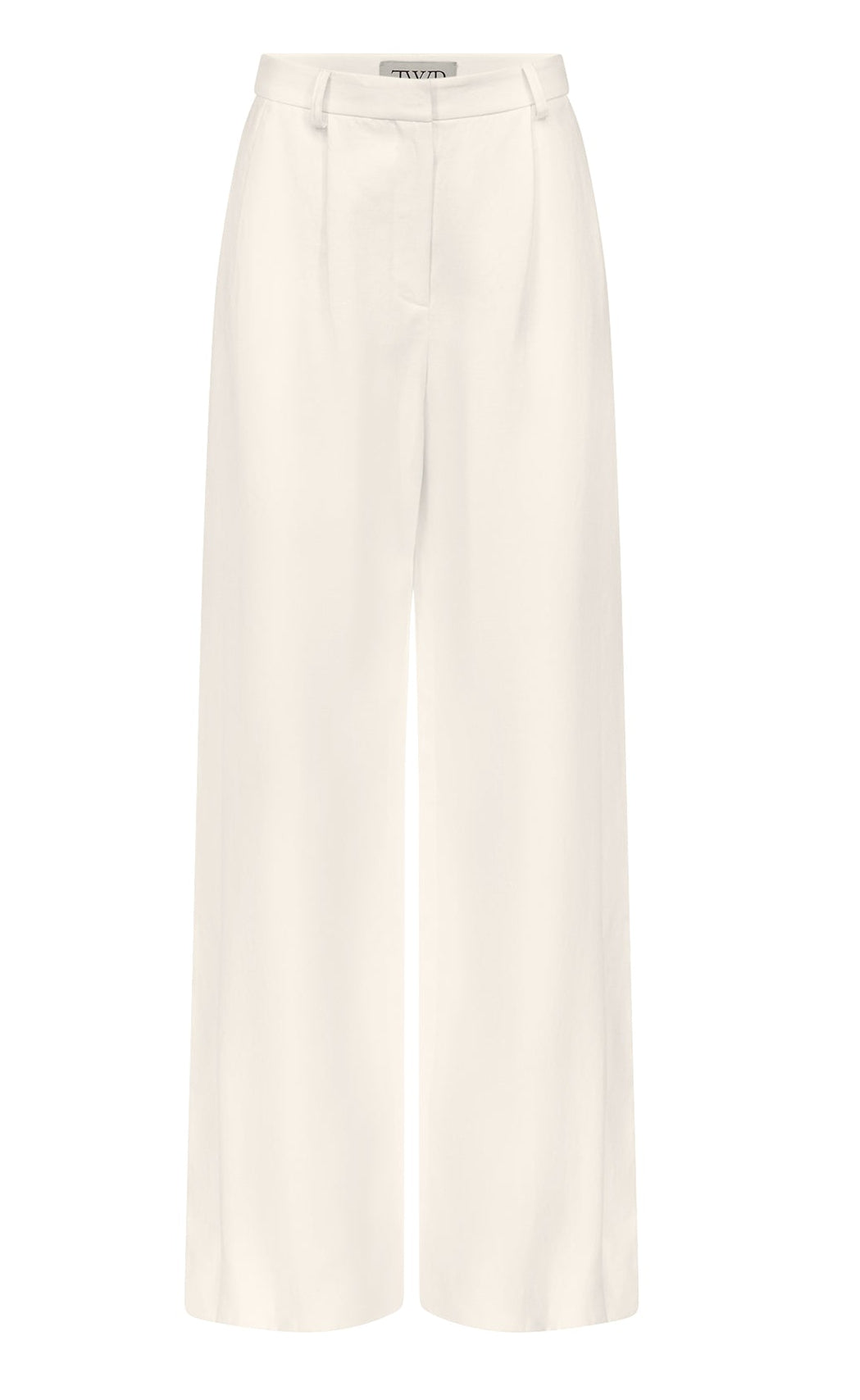The Taite Pant by TWP features white wide-leg 100% linen trousers with a high waist, front pleats, belt loops, and zip fly closure, shown on a plain background.