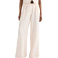 Wearing the TWP Hudson St Pant, styled in a high-waisted wide-leg silhouette with a matching sleeveless top and sandals, the person stands against a plain background.