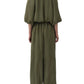 A person viewed from the back wears the Simkhai Freya Parachute Pant in olive green, featuring a drawstring waistband and elasticized ankles.