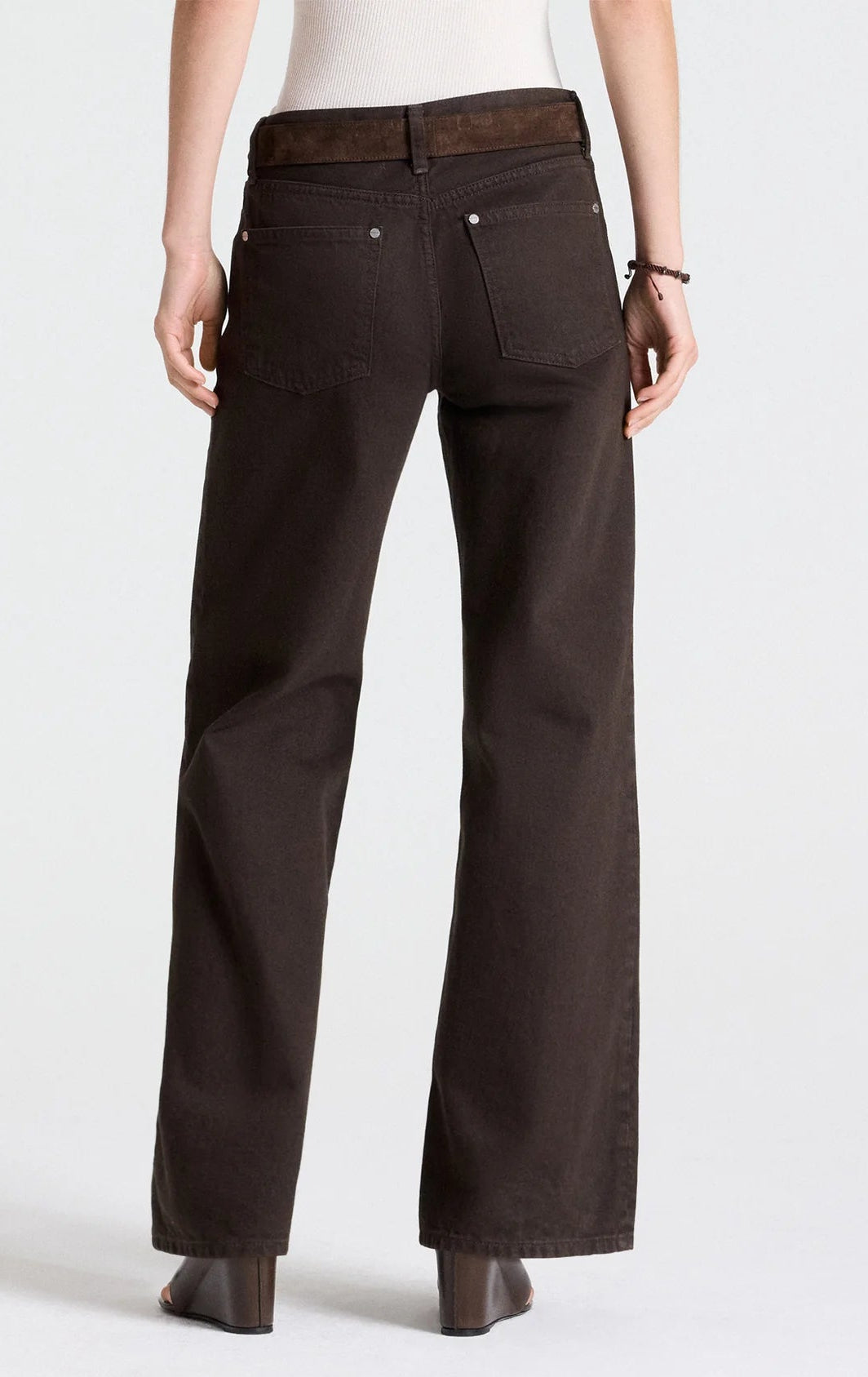 Back view of TWP Harvest Moon Jean in dark chocolate, heavy denim, straight-leg style with a brown suede belt.