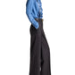 Person in profile wearing a blue ruffled blouse tucked into TWP Isla Pant mid-rise, wide-leg trousers with black heeled sandals.