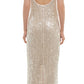 A person is seen from behind wearing the stunning Simkhai Bex Tank Maxi Dress in champagne, showcasing its sleeveless and backless design adorned with shimmering sequins cascading to a floor-length hem.