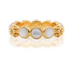 The Berry Gem Ring by Juliska Capucine De Wulf features a row of round white pearls set between clusters of textured gold beads, adding a delicate and elegant touch to any look.