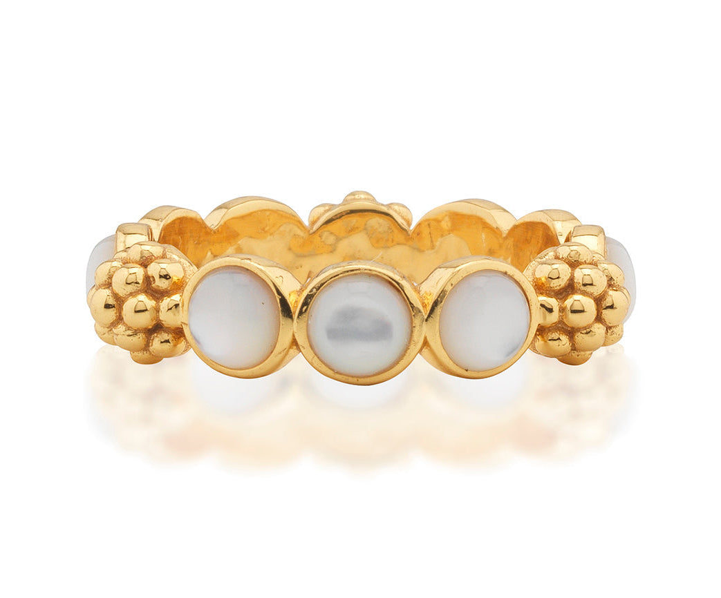 The Berry Gem Ring by Juliska Capucine De Wulf features a row of round white pearls set between clusters of textured gold beads, adding a delicate and elegant touch to any look.