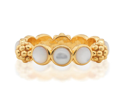 The Berry Gem Ring by Juliska Capucine De Wulf features a row of round white pearls set between clusters of textured gold beads, adding a delicate and elegant touch to any look.
