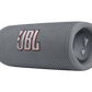 The JBL Flip 6 Waterproof Bluetooth Speaker in gray, featuring a mesh texture and side control button with iconic branding, offers powerful sound for any adventure.