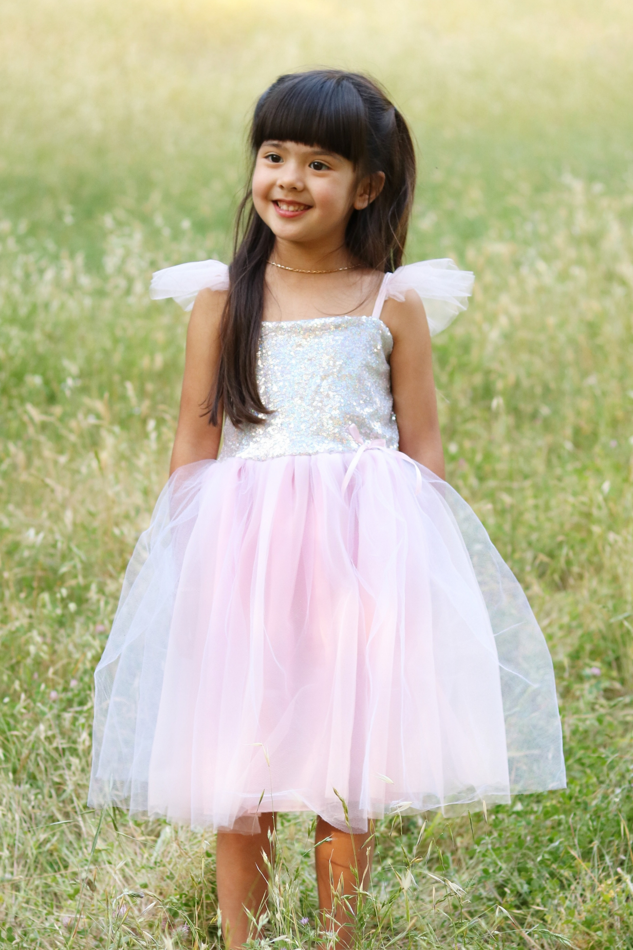 A girl in a Great Pretenders Sequins Princess Dress in lilac.