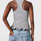 A person shown from the back wears the Stella McCartney Frilled Hem Rib Tank in gray, made from organic cotton, featuring a ribbed texture and frilled hem, paired with blue jeans.
