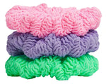 Three Hunza G scrunchies in Bubblegum, Lime, and Lilac are stacked together like a mini set against a white background.