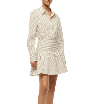 A woman wears the Staud Rocco Mini Dress, featuring beige and white vertical stripes, a fitted waist, and a flared A-line mini skirt.