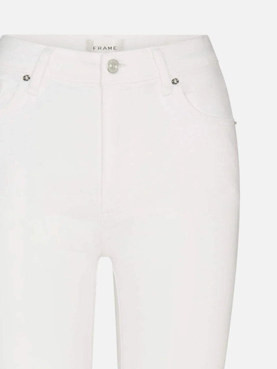 Close-up of The Reboot high-rise bootcut jeans by Frame, in white super-stretch denim with front pockets, belt loops, metallic button, zipper fly, and a visible Frame label inside the waistband.