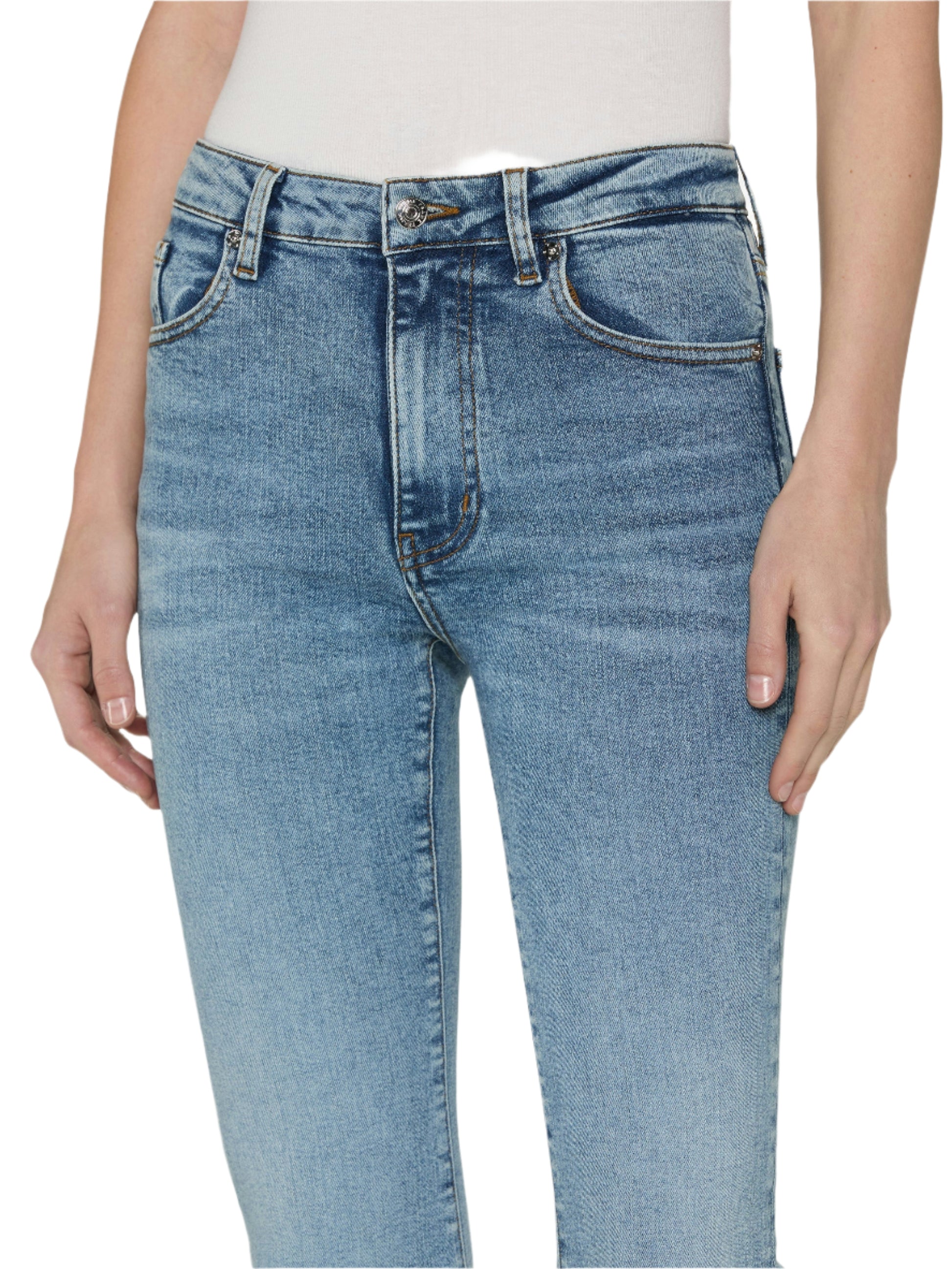 A person wearing Frame’s The Reboot light blue high-rise jeans and a white top, hands by their sides, highlights comfortable denim for an effortless look.